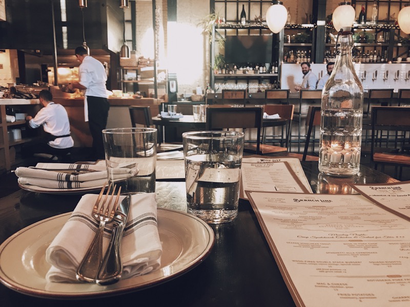 First person view of a person sitting at a high end restaurant table.