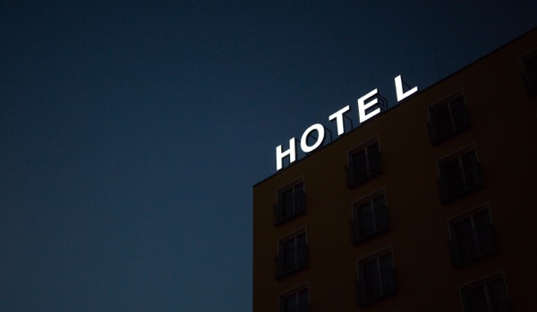 Picture of the dark exterior of a hotel at night.