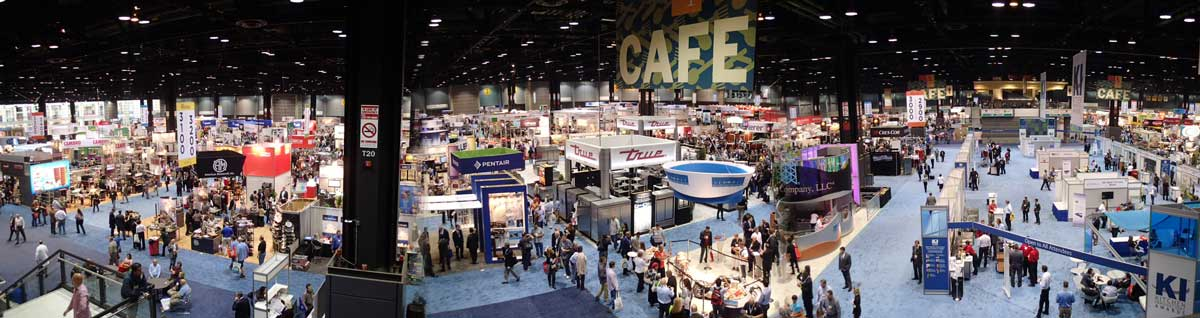 Photo of expansive conference hall full of booths and people.