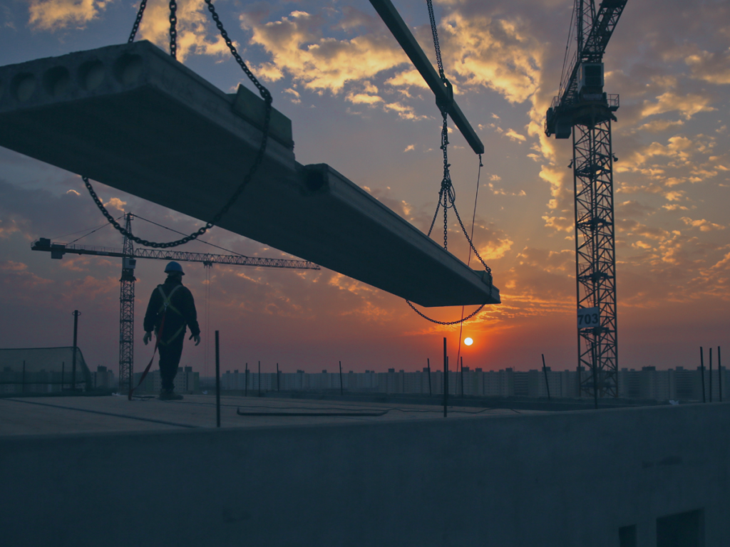 construction worker on site with sunset 