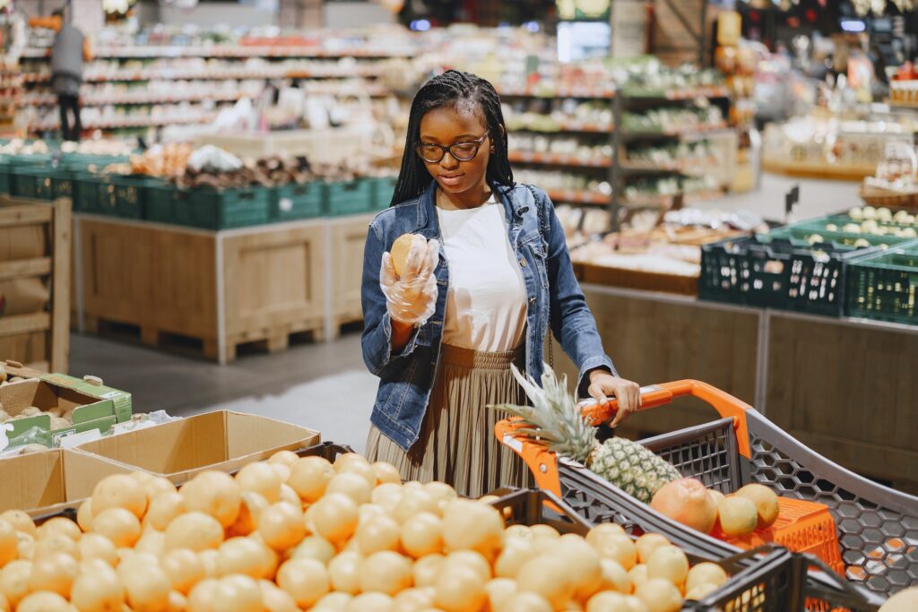 Young woman inspecting produce at grocery store