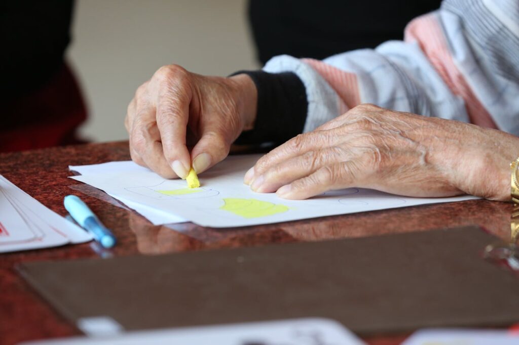 Elderly woman drawing in assisted living