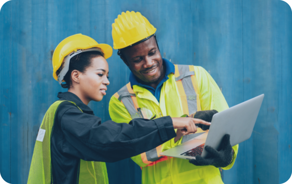 two construction workers autoamting AP on-site with a laptop