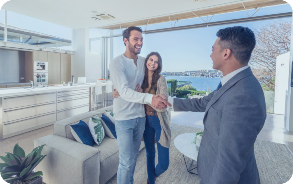 real estate agent showing a couple a home