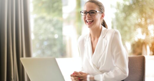 woman smiling while working at a desk
