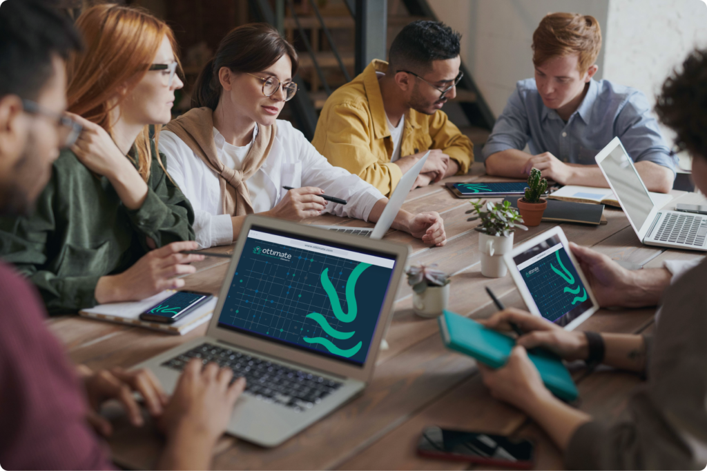 business team going over accounts payable metrics on devices around a conference table