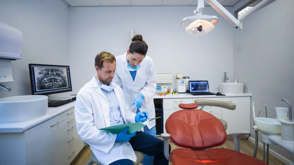 dentists discussing on medical report in clinic