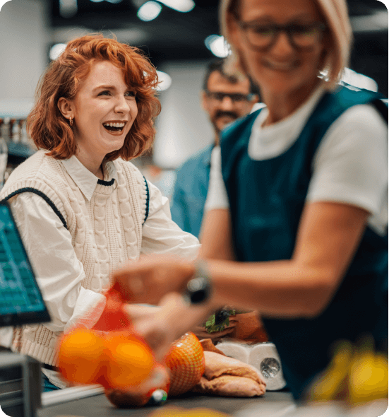Smiling female customer at grocery checkout