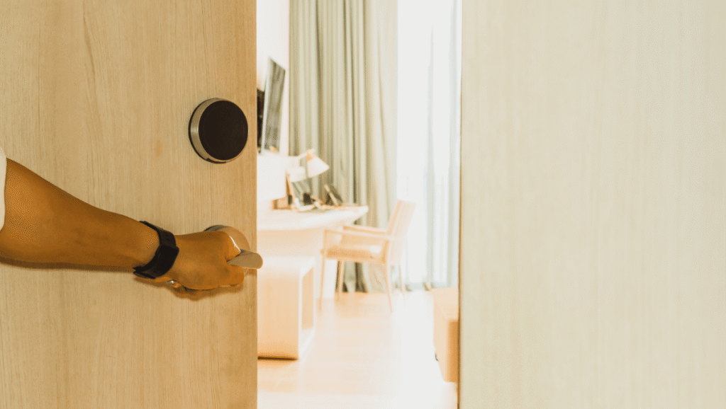 person opening a hotel room door