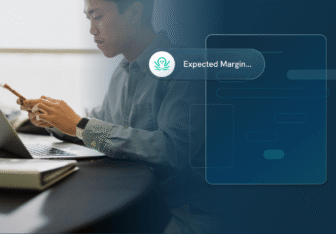 A finance professional at a laptop checks his phone as an Ottimate “Expected Margin” alert appears over a dashboard
